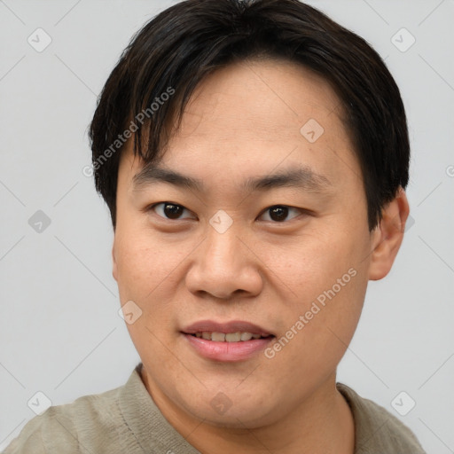 Joyful asian young-adult male with short  brown hair and brown eyes