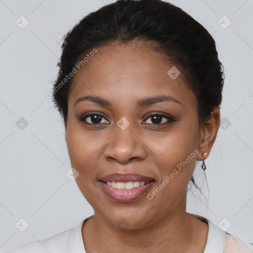 Joyful black young-adult female with short  brown hair and brown eyes