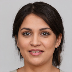 Joyful white young-adult female with medium  brown hair and brown eyes