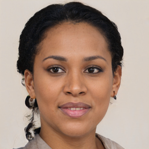 Joyful black young-adult female with short  brown hair and brown eyes