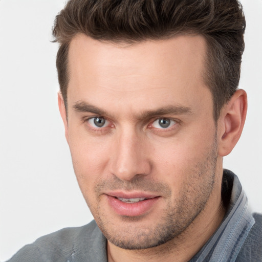 Joyful white young-adult male with short  brown hair and brown eyes