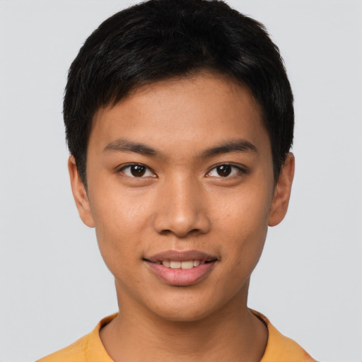 Joyful latino young-adult male with short  brown hair and brown eyes