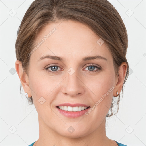 Joyful white young-adult female with medium  brown hair and grey eyes