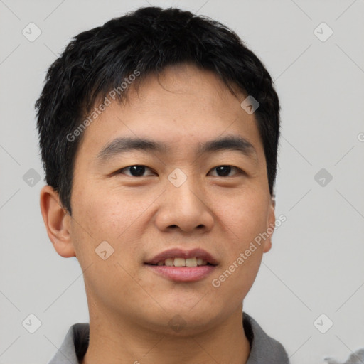 Joyful asian young-adult male with short  black hair and brown eyes