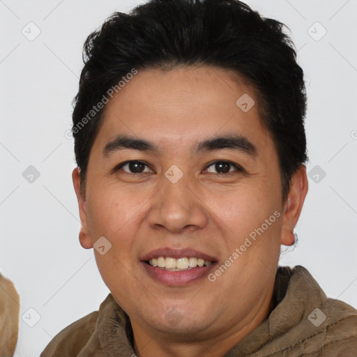 Joyful latino young-adult male with short  brown hair and brown eyes