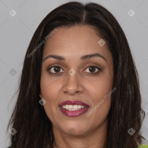 Joyful latino adult female with long  brown hair and brown eyes