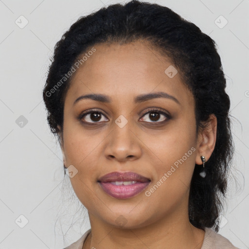 Joyful black young-adult female with long  brown hair and brown eyes