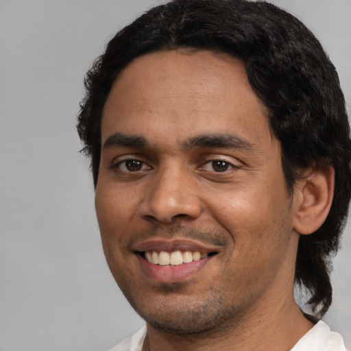 Joyful white young-adult male with short  black hair and brown eyes