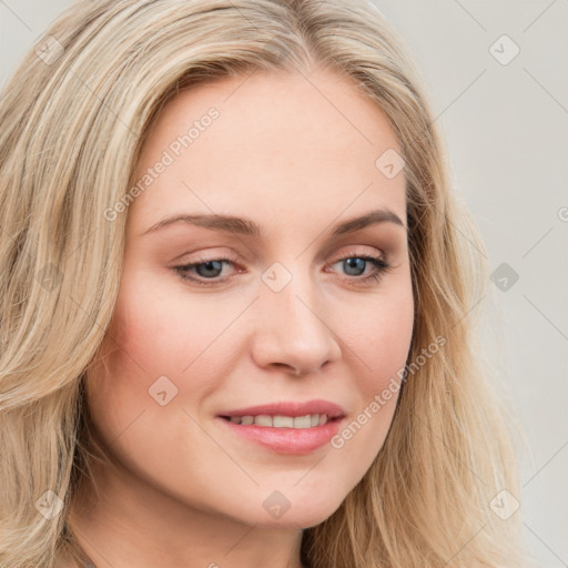 Joyful white young-adult female with long  brown hair and blue eyes