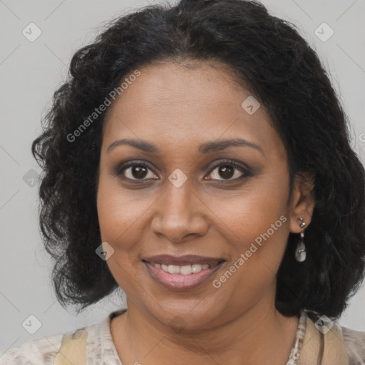 Joyful black adult female with medium  brown hair and brown eyes