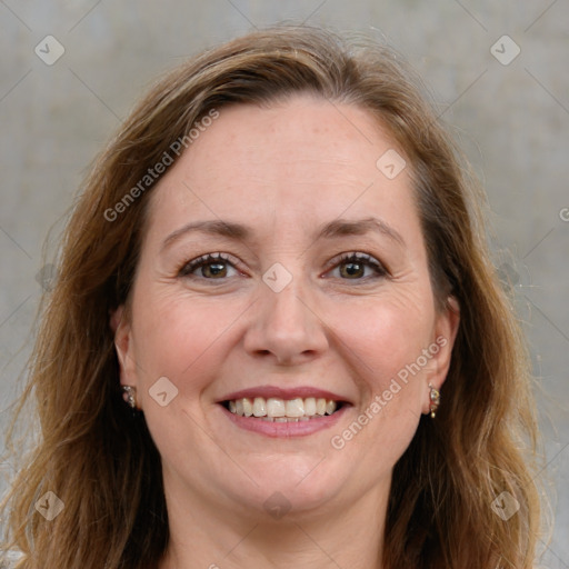 Joyful white adult female with long  brown hair and grey eyes