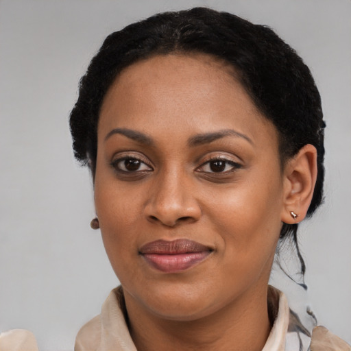 Joyful black young-adult female with medium  black hair and brown eyes