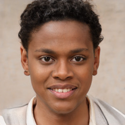 Joyful black young-adult male with short  brown hair and brown eyes