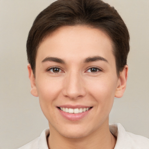 Joyful white young-adult female with short  brown hair and brown eyes