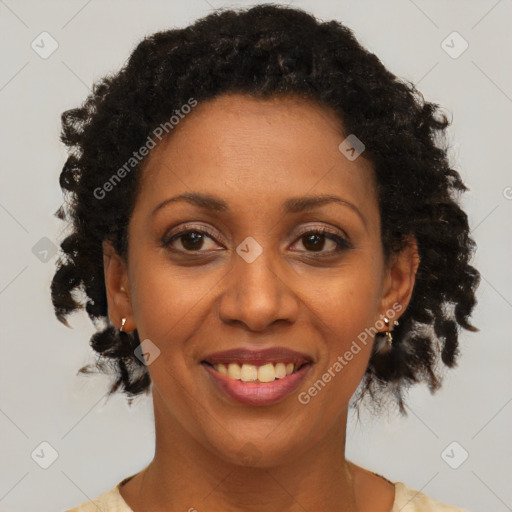 Joyful black adult female with short  brown hair and brown eyes