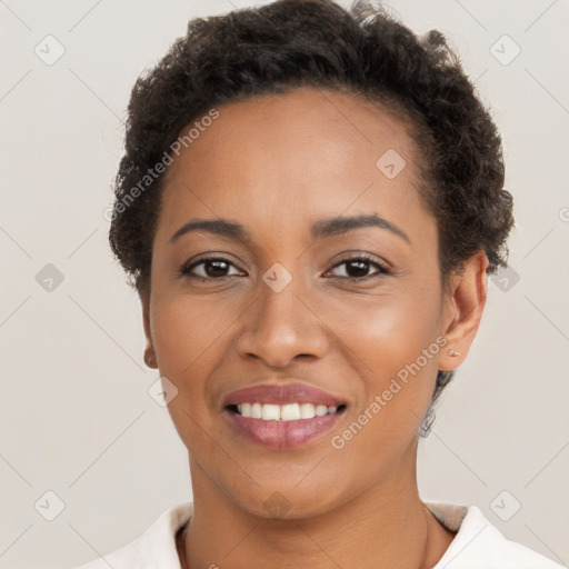 Joyful black young-adult female with short  brown hair and brown eyes