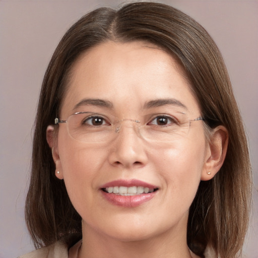 Joyful white adult female with medium  brown hair and brown eyes