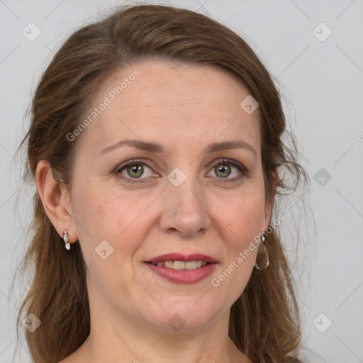 Joyful white adult female with long  brown hair and grey eyes