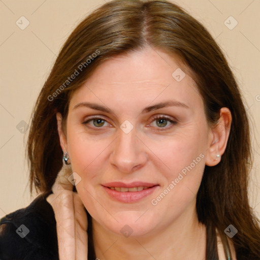 Joyful white adult female with long  brown hair and brown eyes