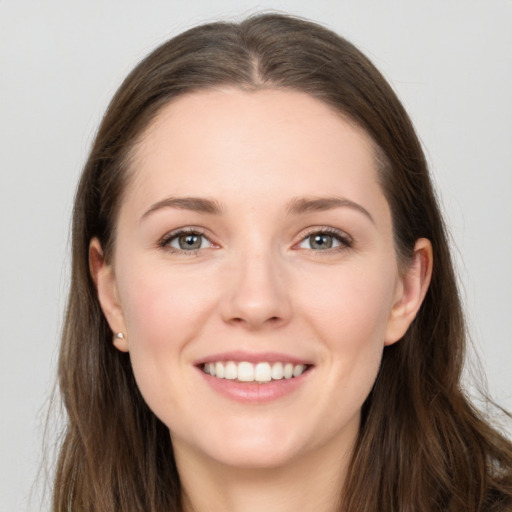 Joyful white young-adult female with long  brown hair and grey eyes