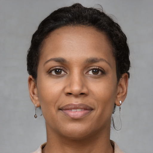 Joyful latino young-adult female with short  brown hair and brown eyes