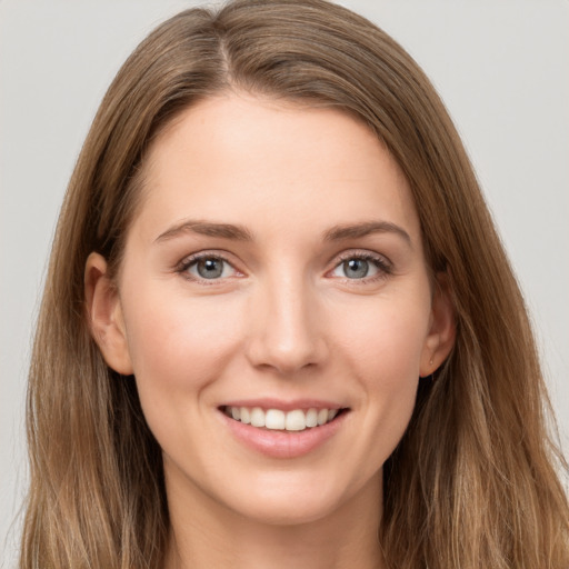 Joyful white young-adult female with long  brown hair and grey eyes