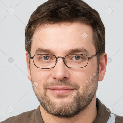 Joyful white young-adult male with short  brown hair and grey eyes