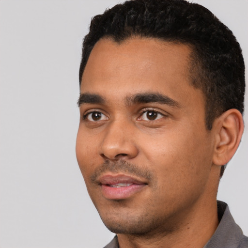 Neutral latino young-adult male with short  black hair and brown eyes