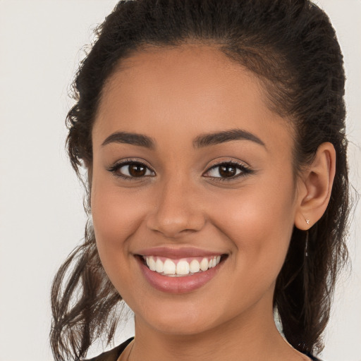 Joyful white young-adult female with long  brown hair and brown eyes