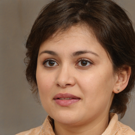 Joyful white young-adult female with medium  brown hair and brown eyes