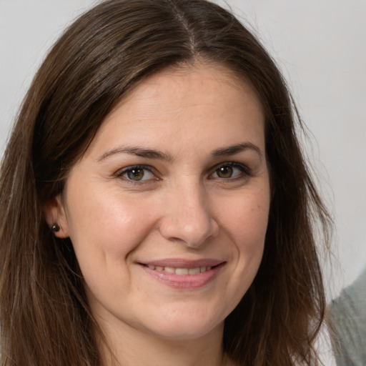 Joyful white young-adult female with long  brown hair and brown eyes