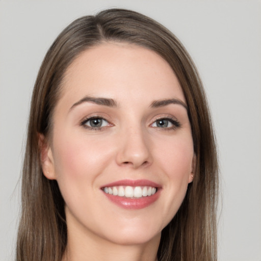 Joyful white young-adult female with long  brown hair and grey eyes