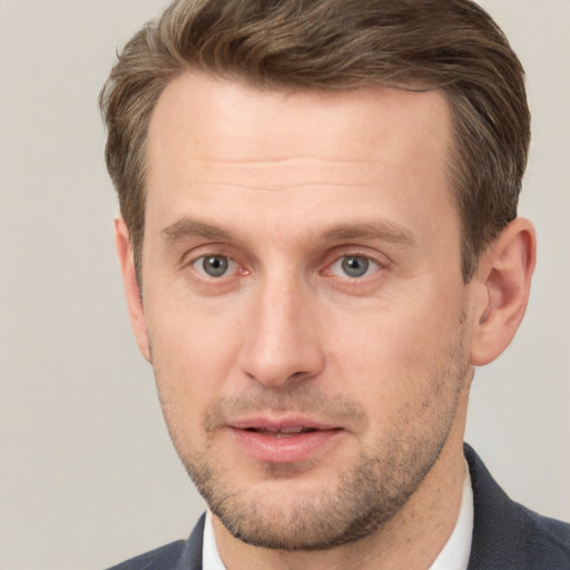 Joyful white adult male with short  brown hair and grey eyes