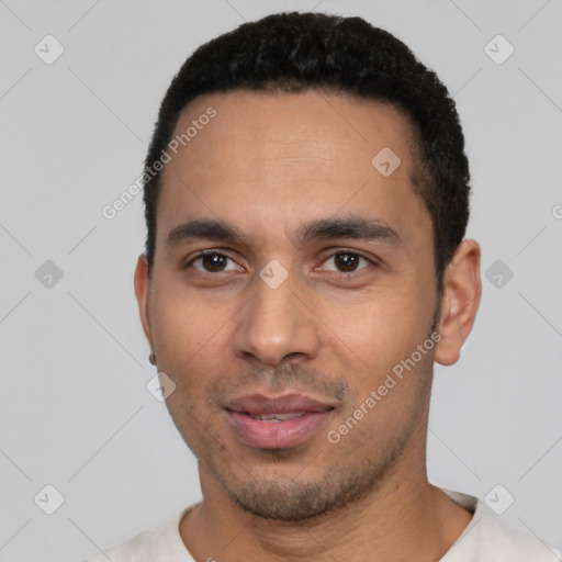 Joyful latino young-adult male with short  black hair and brown eyes