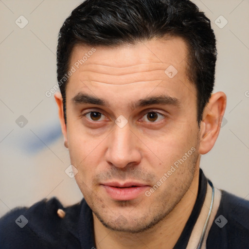 Joyful white young-adult male with short  brown hair and brown eyes