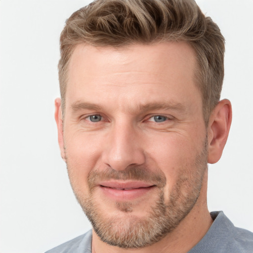 Joyful white adult male with short  brown hair and grey eyes