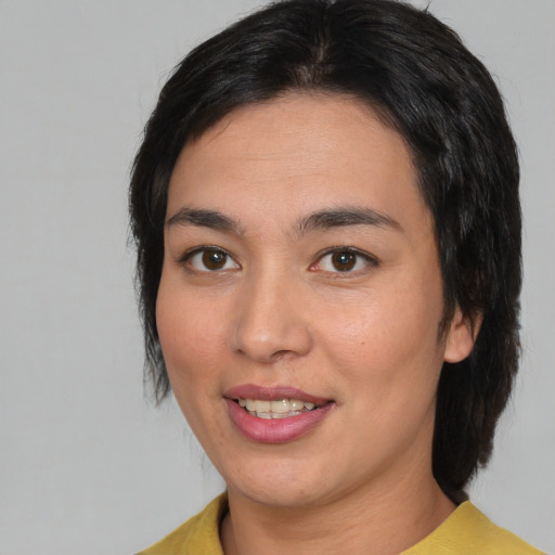 Joyful white young-adult female with medium  black hair and brown eyes