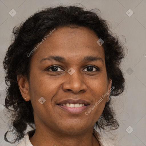 Joyful black adult female with medium  brown hair and brown eyes