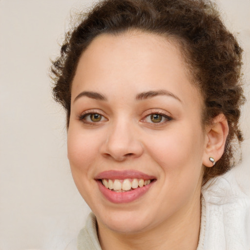 Joyful white young-adult female with medium  brown hair and green eyes