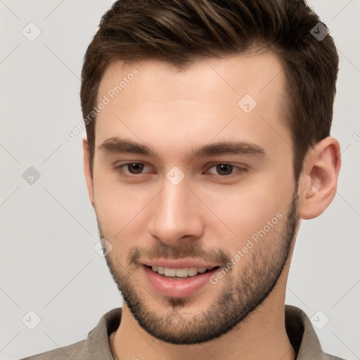 Joyful white young-adult male with short  brown hair and brown eyes