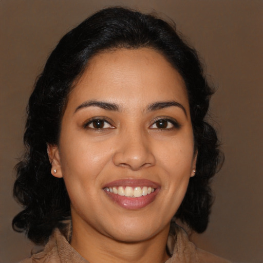 Joyful latino young-adult female with long  brown hair and brown eyes