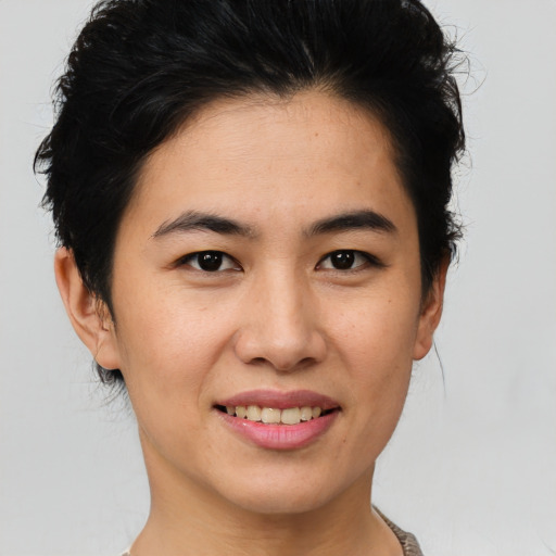 Joyful asian young-adult female with short  brown hair and brown eyes