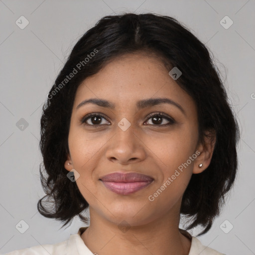 Joyful black young-adult female with medium  brown hair and brown eyes