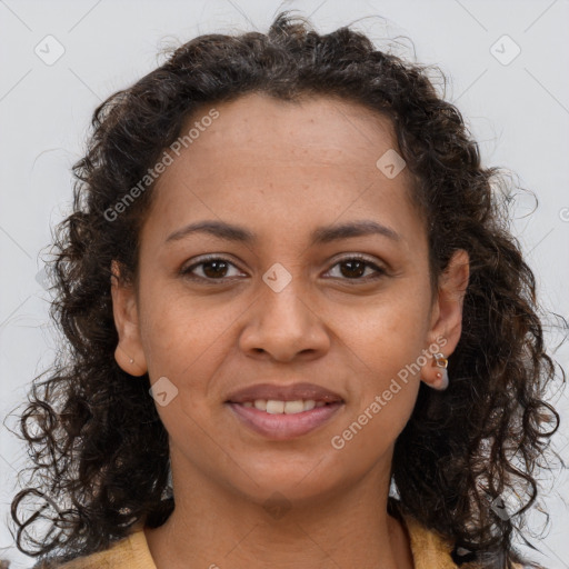 Joyful black young-adult female with long  brown hair and brown eyes