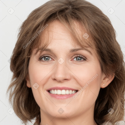 Joyful white adult female with medium  brown hair and grey eyes