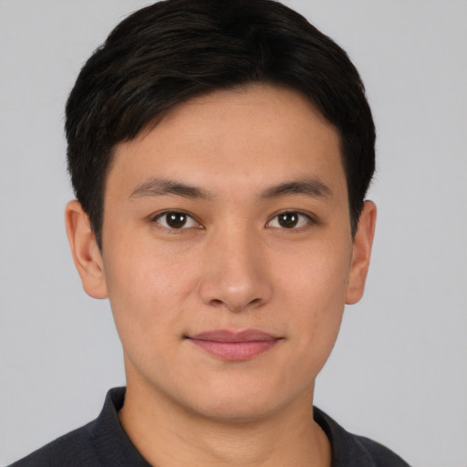Joyful asian young-adult male with short  brown hair and brown eyes