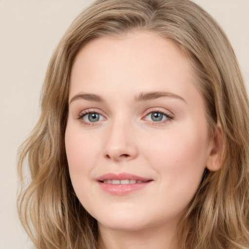 Joyful white young-adult female with long  brown hair and blue eyes