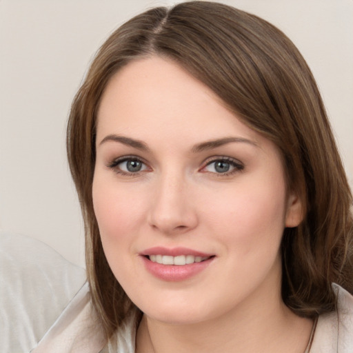 Joyful white young-adult female with medium  brown hair and grey eyes