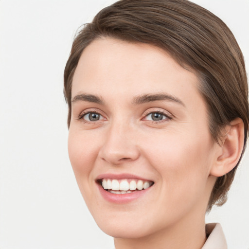 Joyful white young-adult female with medium  brown hair and green eyes