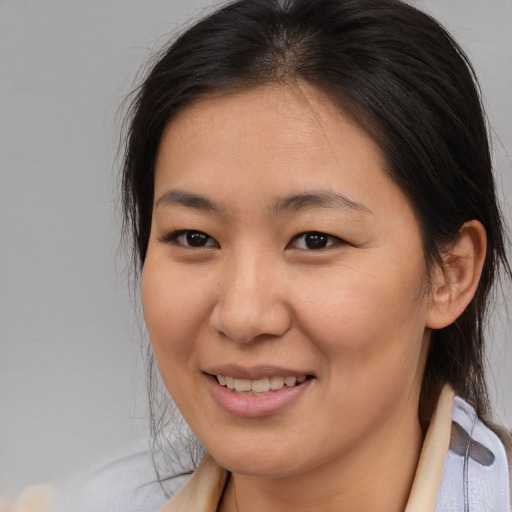 Joyful asian young-adult female with medium  brown hair and brown eyes